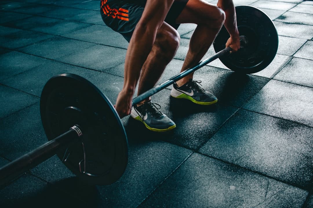 Shared workout card over a photo of a lifter gripping a barbell